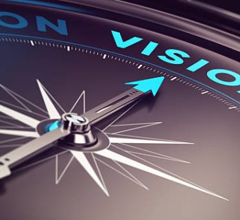 Compass with needle pointing the word vision with blur effect plus blue and black tones. Conceptual image for immustration of company or business anticipation or strategy